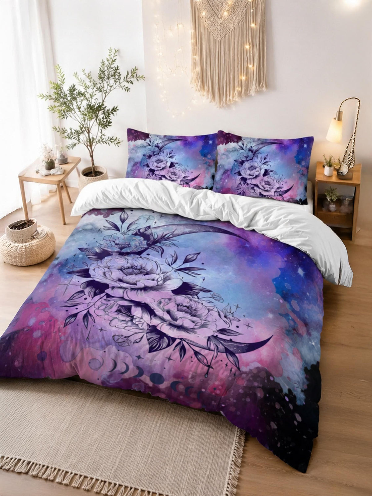 May include: A bedding set featuring a duvet cover and two pillowcases with a galaxy-inspired print in shades of purple, blue, and pink. The design includes a large crescent moon adorned with detailed floral illustrations and star motifs.