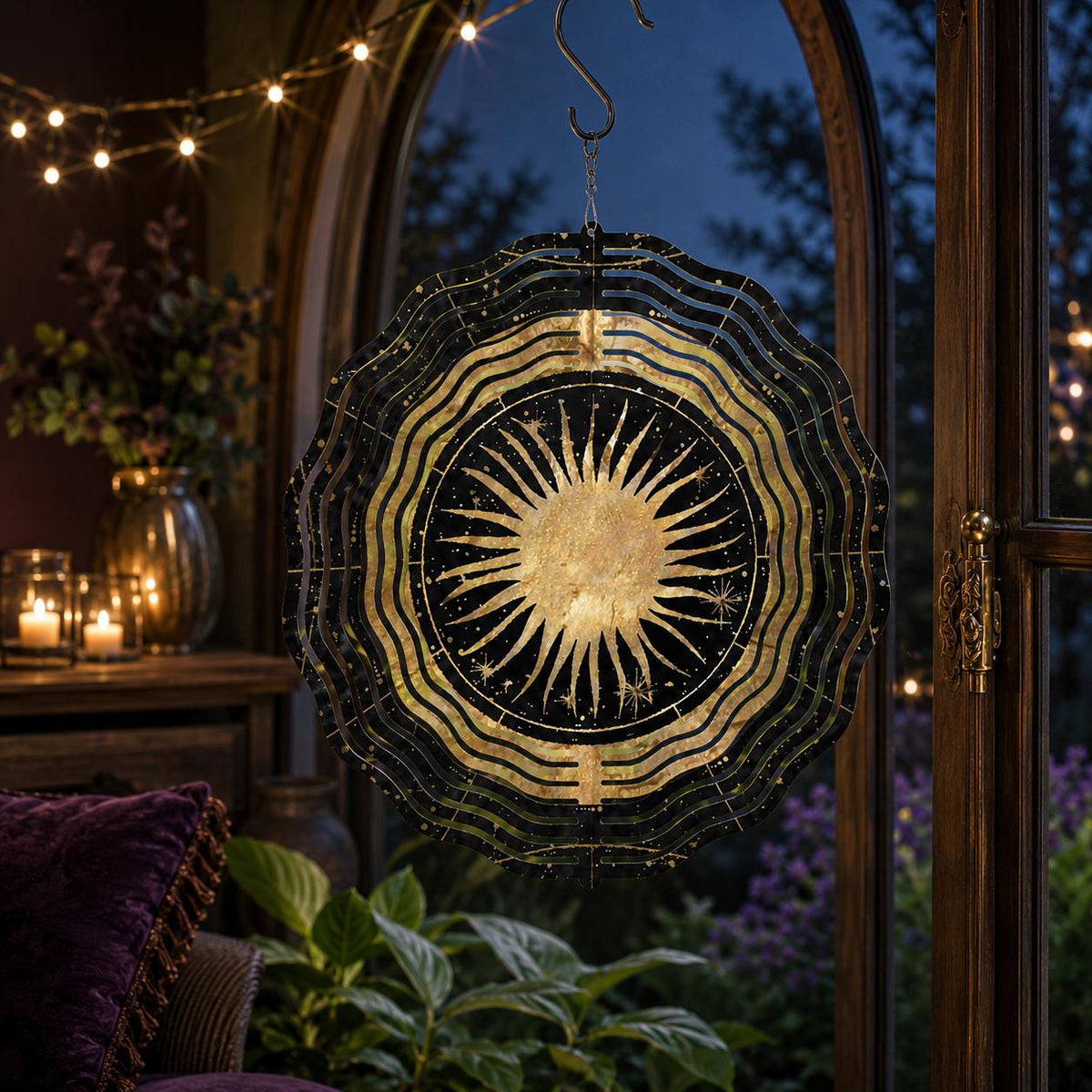 May include: A circular metal wind spinner featuring a central gold sun design on a black background with gold star accents. The outer edges have a wavy, layered pattern in black and gold. It hangs from a metal hook and chain, designed for rotation.