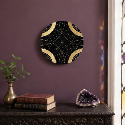 May include: A circular wall clock featuring a black background with gold celestial constellations and geometric lines. The clock face is divided into four quadrants by gold arcs, with thin gold hands centered on the dark, star-patterned surface.