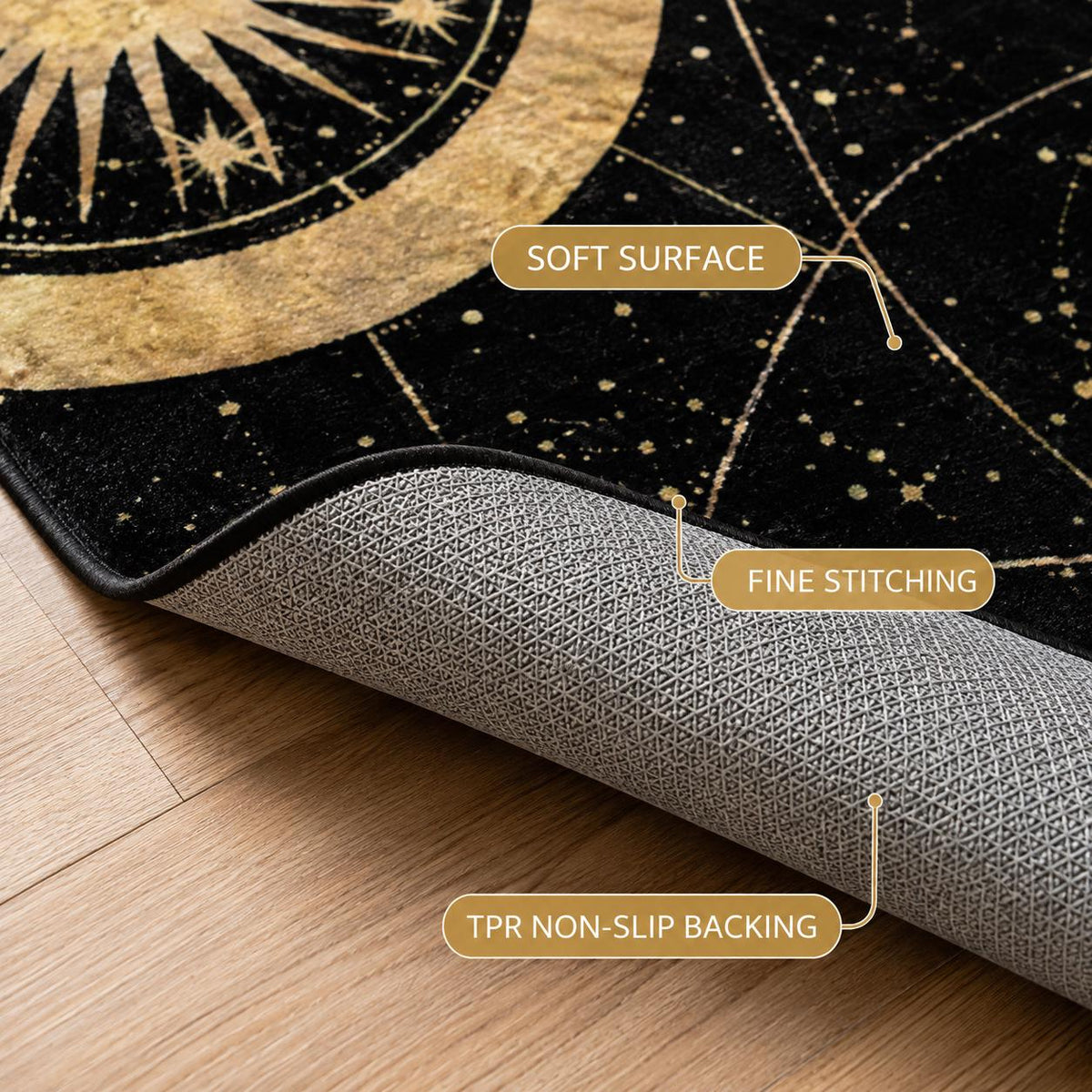 May include: A black rug featuring a gold celestial sun and star pattern with a soft surface, fine stitching along the edges, and a grey TPR non-slip backing. The rug is partially folded to reveal the textured underside and the black top surface.