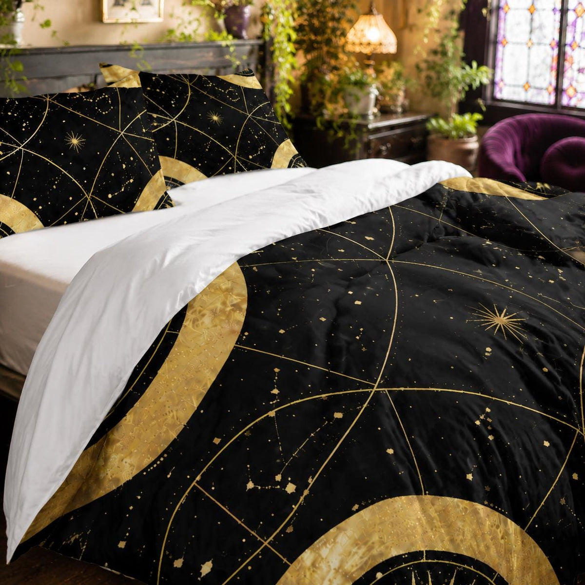 May include: A black comforter and matching pillow shams featuring a gold celestial print with constellations, stars, and circular geometric patterns. The bedding set is partially folded back to reveal a solid white underside on the comforter.