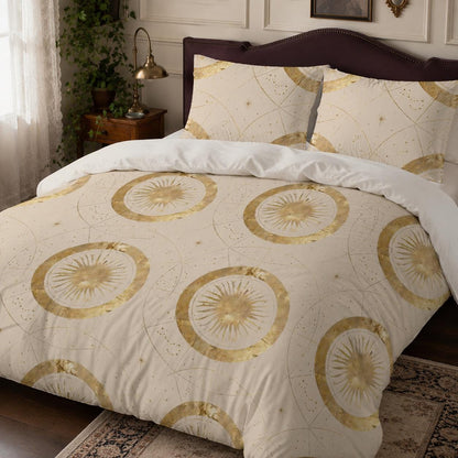 May include: A cream-colored duvet cover and two matching pillowcases featuring a repeating pattern of gold sunbursts, thin circular lines, and small star-like dots. The bedding set has a light background with metallic gold printed celestial motifs.