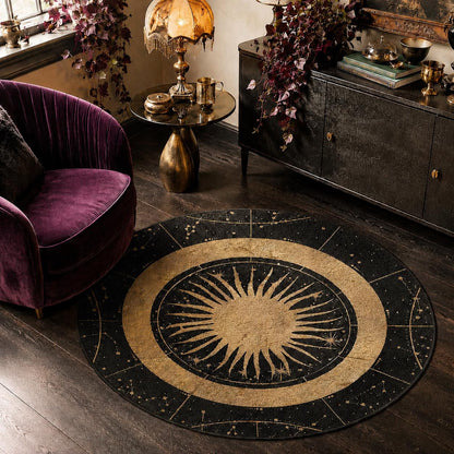 May include: A circular area rug featuring a central gold sun motif with radiating rays, surrounded by a black border decorated with gold celestial patterns, including stars and constellations, arranged in a radial design on a dark floor.