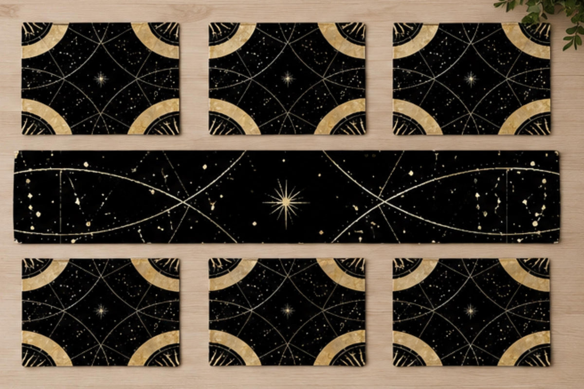May include: A set of six rectangular placemats and one long rectangular table runner, all featuring a black background with a gold celestial pattern of stars, constellations, and curved lines forming circular geometric shapes across the surface.