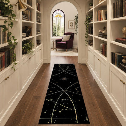 May include: A long, rectangular runner rug featuring a black background with a white celestial pattern of thin intersecting lines, starbursts, and scattered dots that mimic a star map or constellation chart, laid out on a wooden floor.